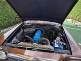 an old car with its hood open on the street
