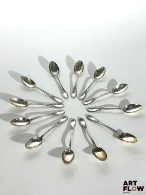 many spoons arranged in a circle on a table