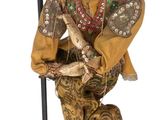 statue of a man sitting on a stool holding a guitar