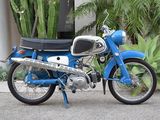 a blue motorcycle that is parked in front of a building