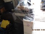 a pile of boxes and a printer in a room