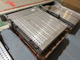 a metal tray on a pallet in a warehouse