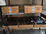 many boxes of files on a shelf in a room