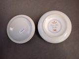 two white plates with blue designs on them sitting next to each other