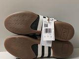 two pairs of brown and white shoes with a price tag on them