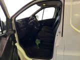 a white van with the door open and a green plant in the passenger seat