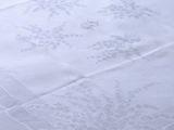 a white table cloth with a design on it