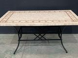 une petite table avec un plateau en carrelage et des pieds en métal