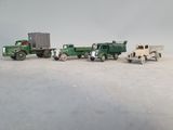several toy trucks are lined up in a row on a white surface