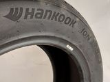 a close up of a tire on a white surface