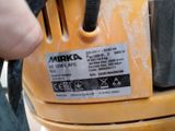 a close up of a person using a machine to cut a piece of wood