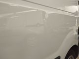 the side of a white van is parked in a garage