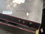 an image of a counter top pizza oven in a warehouse