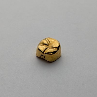 an image of a gold ring with a face on it
