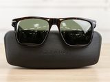 a close up of a pair of sunglasses on a wooden table