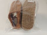 a pair of shoes in a plastic bag on a table