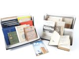 several books are in a box on a white surface