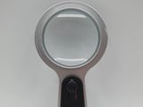 a close up of a magnifying glass on a white surface