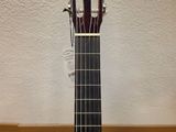 a close up of a guitar on a stand on a wooden floor