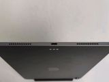 a close up of the back of a laptop computer on a white surface
