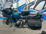 a motorcycle parked in front of a wall with graffiti on it