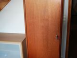 a wooden door and stairs in a small room