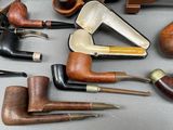 many different types of smoking pipes on the table