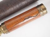 an old telescope with a wooden handle and a leather case