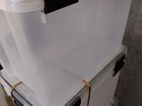 a stack of white boxes with black handles on top of each other