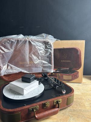 a suitcase with a record player in it sitting on a table