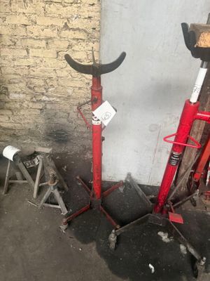 two red and black tools that are on the ground