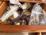 a drawer full of silverware and other items in it