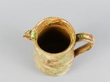 an image of a ceramic pitcher on a white surface