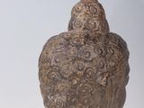 sculpture of a head of a buddha on a white surface