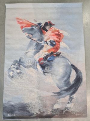 un tableau représentant un homme à cheval sur la plage