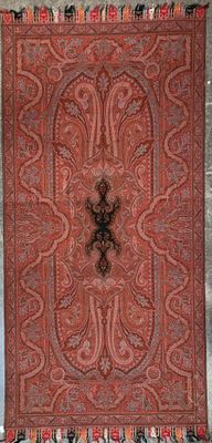 an old rug with a cross on it hanging on a wall