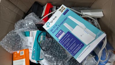 a cardboard box full of electronics and other items in it