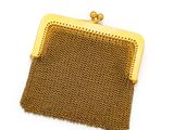 a gold mesh purse on a white background