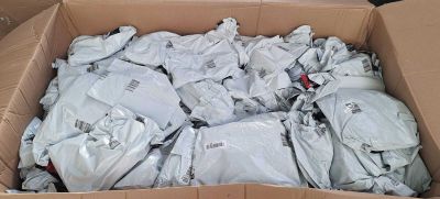 a cardboard box full of white shirts and other items