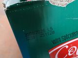 a green container with a red and white label on it