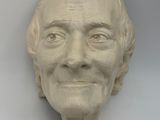 a sculpture of a man ' s face on the wall