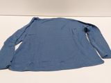 the back of a blue shirt sitting on top of a white table
