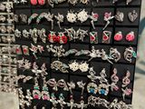 a close up of a display of earrings on display in a store