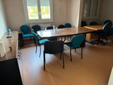 a table and chairs in a room with a large window