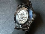 a watch that is sitting on top of a black table