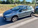 a small silver car parked on the side of the road