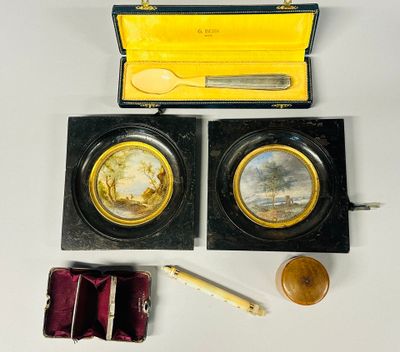 a small box with two gold coins and a wooden box with a spoon