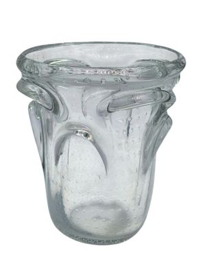 a glass vase that has a handle on it