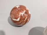 two balls of marble on a table with a white background
