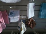 many towels hanging on the wall in a store